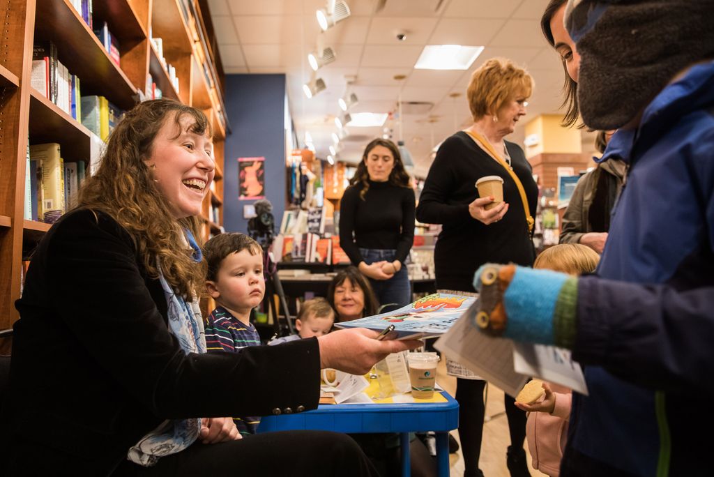 Sheila Cordner at a book-reading event surrounded by young readers.