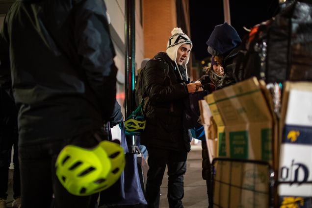 A photo of student Lucas Conti giving a homeless woman in need of some food, a box of granola bars, gloves, socks and toiletries during the 40th annual homeless census.