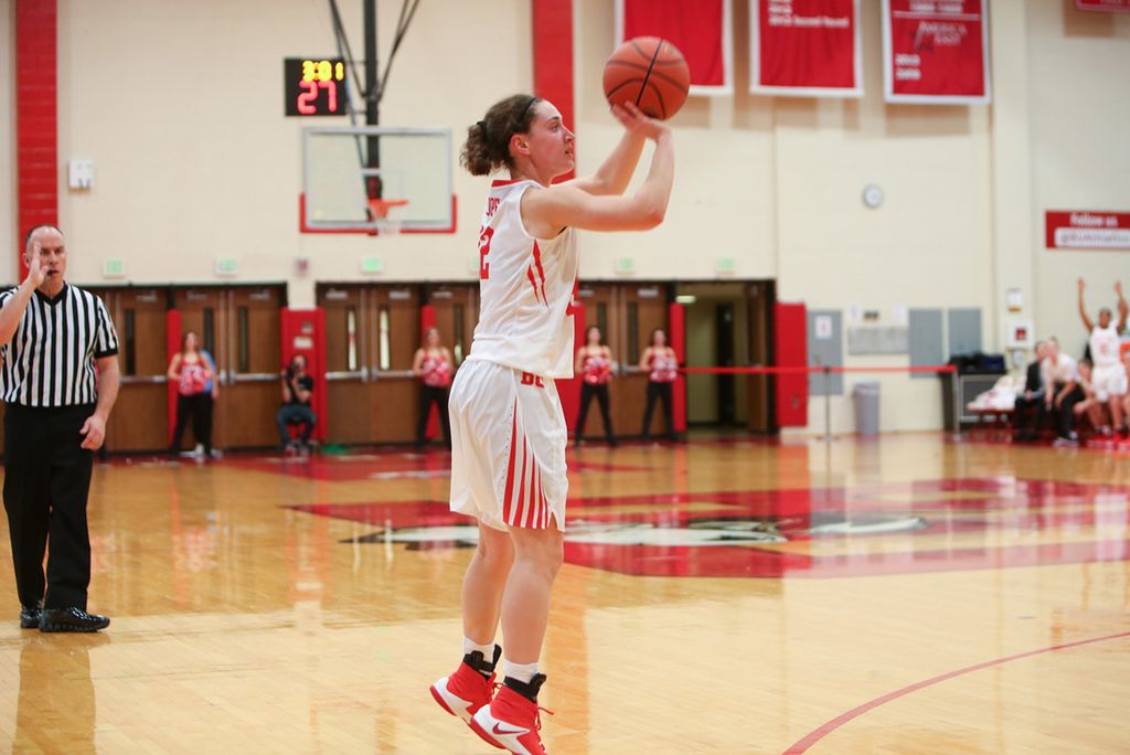 A photo of Sarah Hope (COM’17) shooting a basketball.