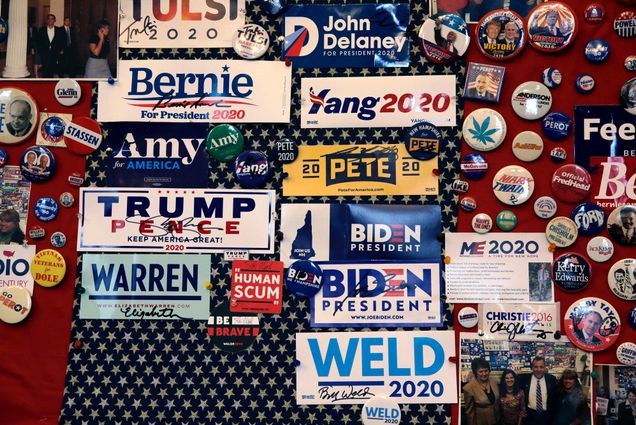 A collection of presidential candidate bumper stickers adorn a wall.