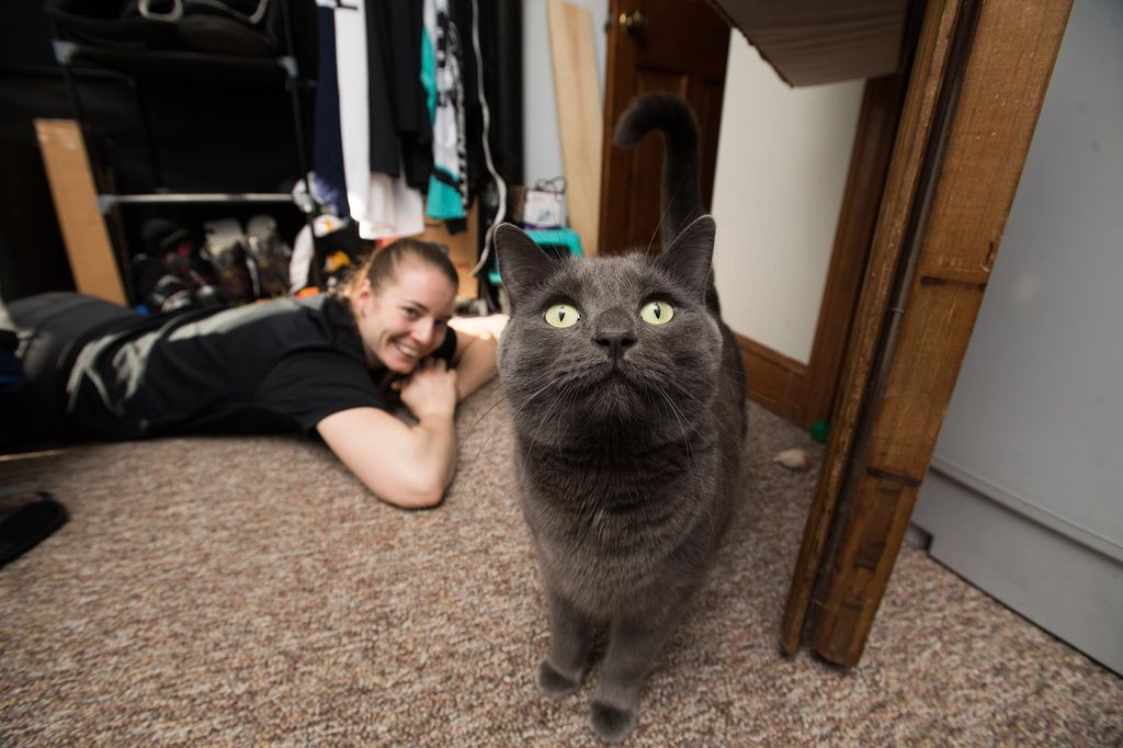 Jetta Rackleff plays on the floor with her cat Ioan