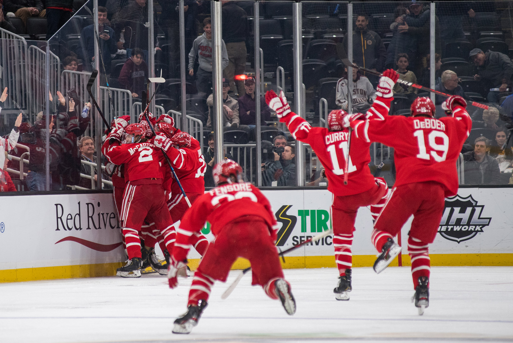 The BU men's hockey team celebrates after their Beanpot semifinal victory.