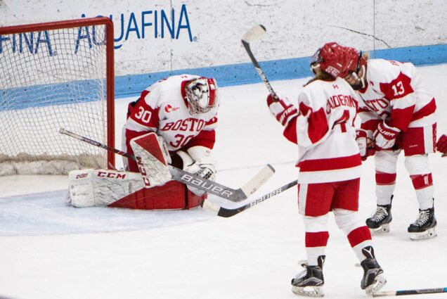 Boston University womens ice hockey goaltender makes a save as other players look on during the 2020 Beanpot tournament championship game.