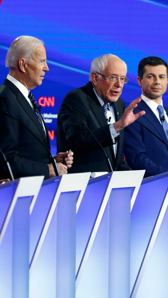 2020 Democratic Presidential candidates Tom Steyer, Elizabeth Warren, Joe Biden, Bernie Sanders, Pete Buttigieg, and Amy Klobuchar on stage during the Iowa Democratic Debate.