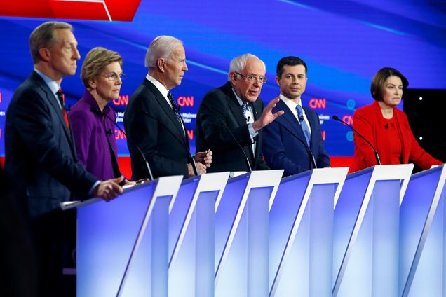 2020 Democratic Presidential candidates Tom Steyer, Elizabeth Warren, Joe Biden, Bernie Sanders, Pete Buttigieg, and Amy Klobuchar on stage during the Iowa Democratic Debate.