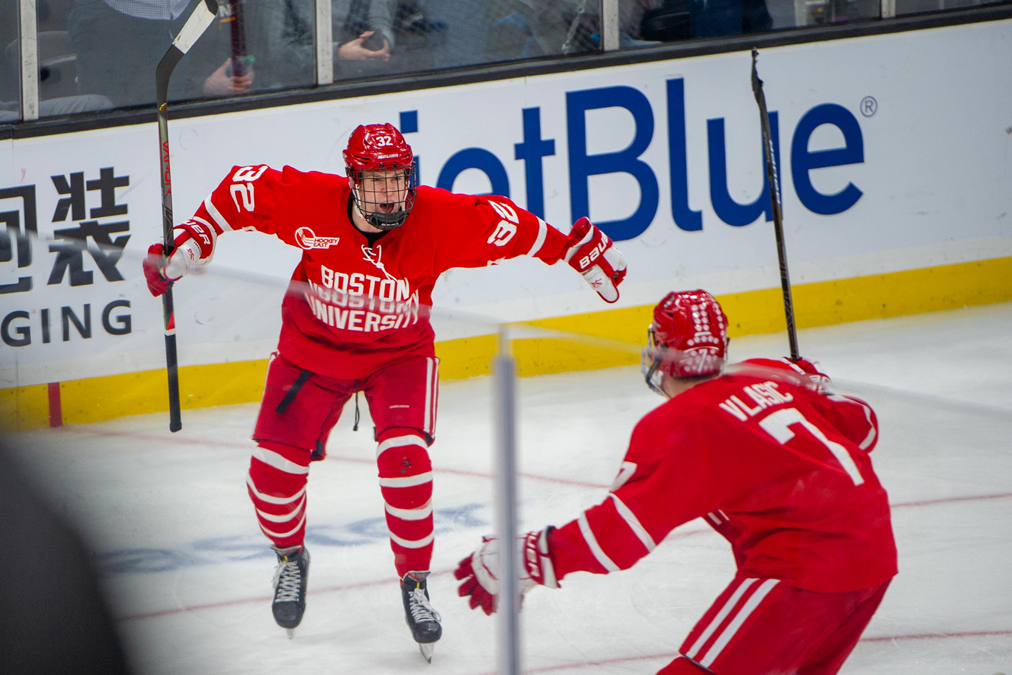 Boston University's Trevor Zegras (13) celebrates his goal as Northeastern  players look on during the first period of the Beanpot Tournament  championship NCAA college hockey game in Boston, Monday, Feb. 10, 2020. (