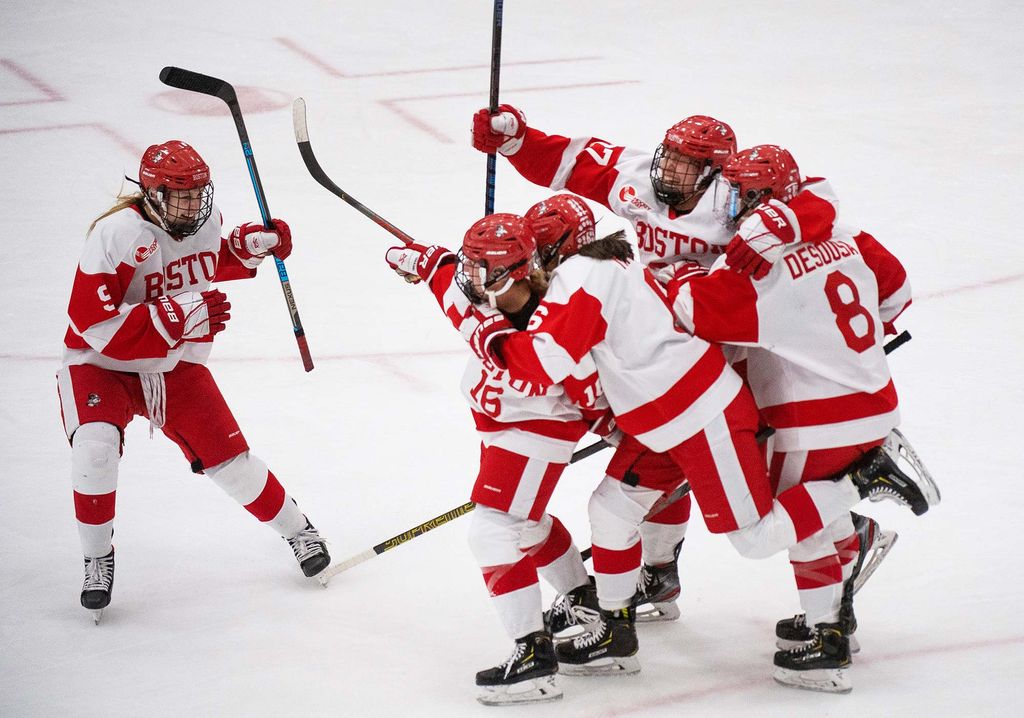 BU Terriers women's ice hockey player Sammy Davis celebrates with teammates after scoring the game tying goal with 22.8 seconds left in the third period of the 42nd Annual Beanpot tournament final game.