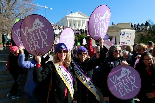 Equal Rights Amendment supporters hold signs with "VA Ratify ERA" outside the Virginia State Capitol in Richmond.