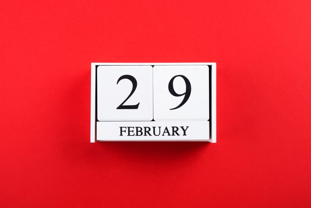 Image of white blocks on a bright red background; blocks say February 29.