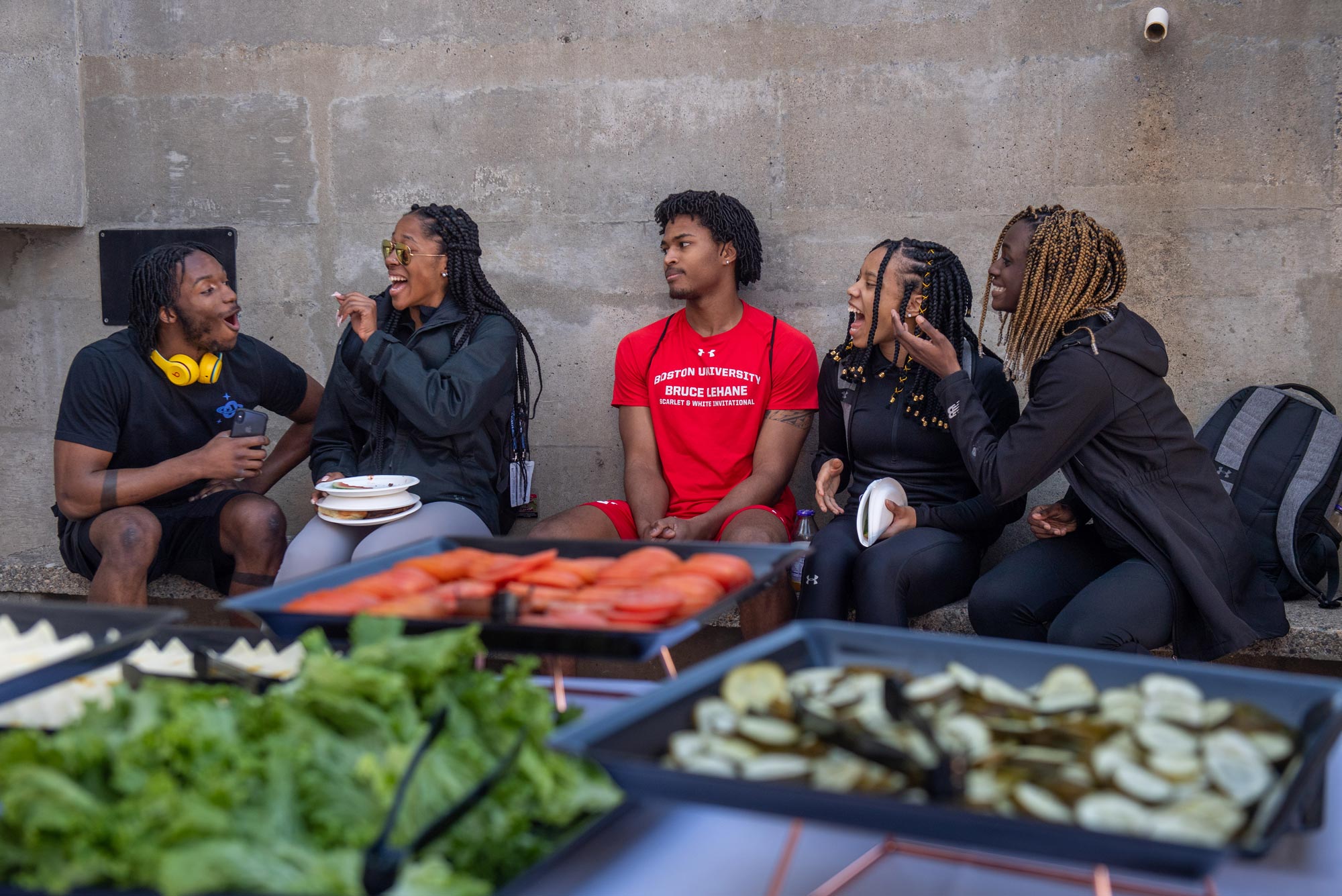 Chiebuka Onwuzurike (QST’20) from left, Alicia Thomas (CAS’22), Jamin Harris (ENG’20), Leah Fowlkes (QST’20) and Noelani Phillips (CAS’23) enjoy the nice weather and the Student Activities Office’s BBQ and rally before the women’s basketball game at CASE March 9, 2020 on West Campus.