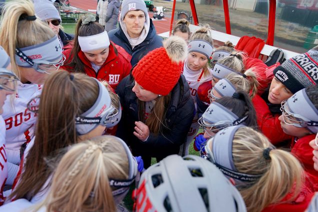 A photo of the Boston University women’s lacrosse team in a huddle