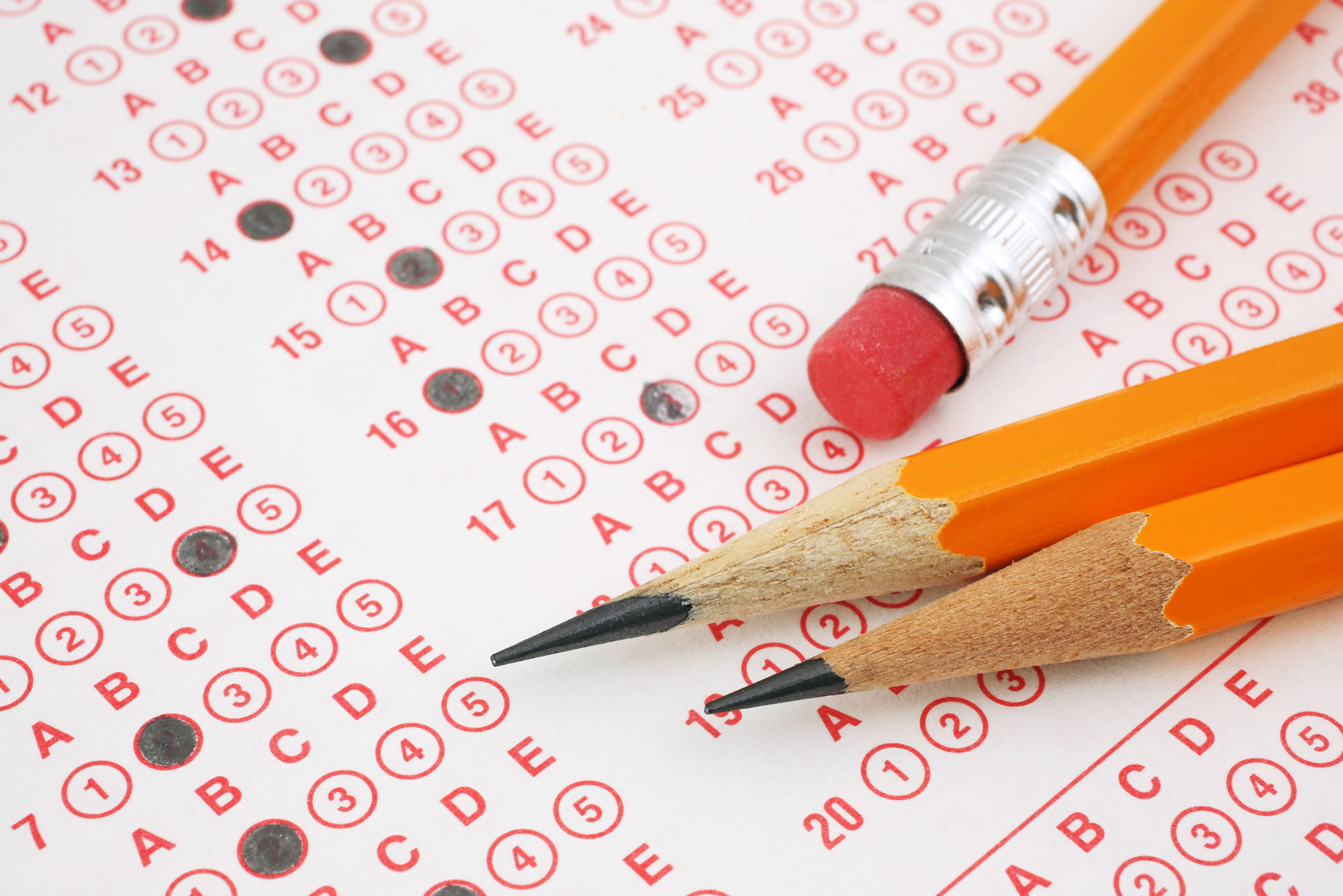 A photo of pencils laying on a partially filled out standardized test