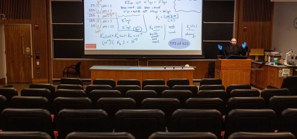 Senior Lecturer in Chemistry Binyomin Abrams gives a remote lecture using a laptop and his smart-podium at Boston University.