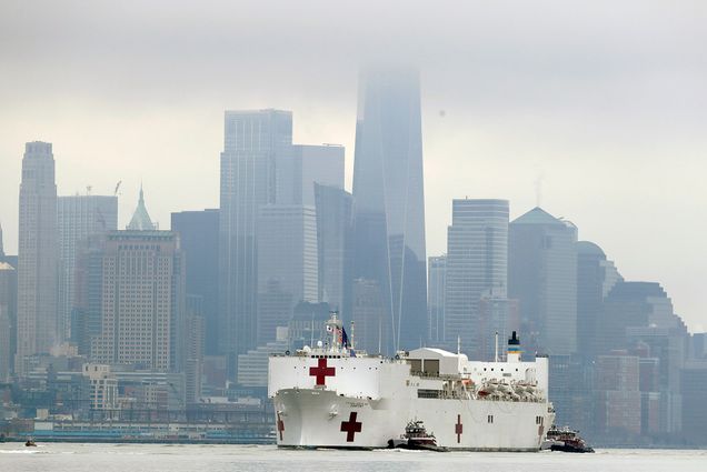 Photo of the Navy hospital ship USNS Comfort passes lower Manhattan on its way to docking in New York, Monday, March 30, 2020, with a foggy Manhattan skyline in the background.