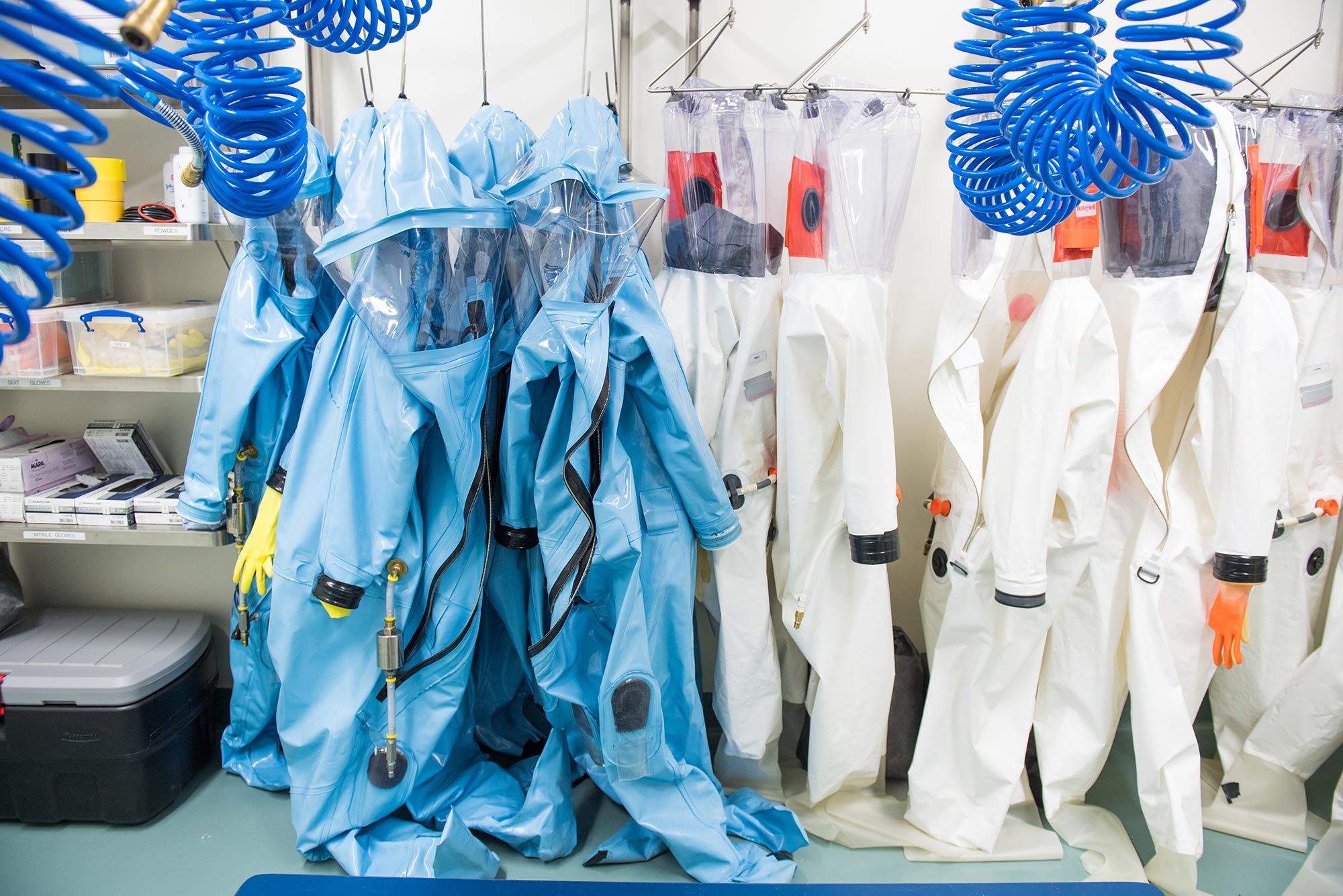 Photo of blue suits hanging up in a lab at BU's NEIDL.