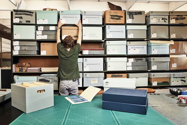 Photo of a student worker at the Howard Gotlieb Archival Research Center filing archive boxes.