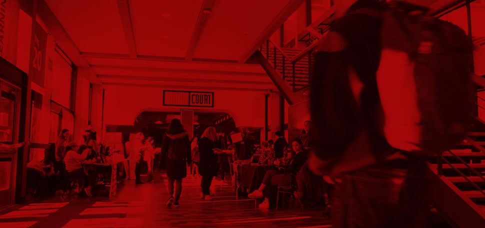 Still from "Students on the Issues That Matter Most to Them in the 2020 Presidential Election" video; photo of students walking in the hallway leading to Union Court with red overlay.