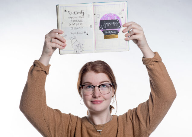 A photo of Abbey McCracken with her bullet journal