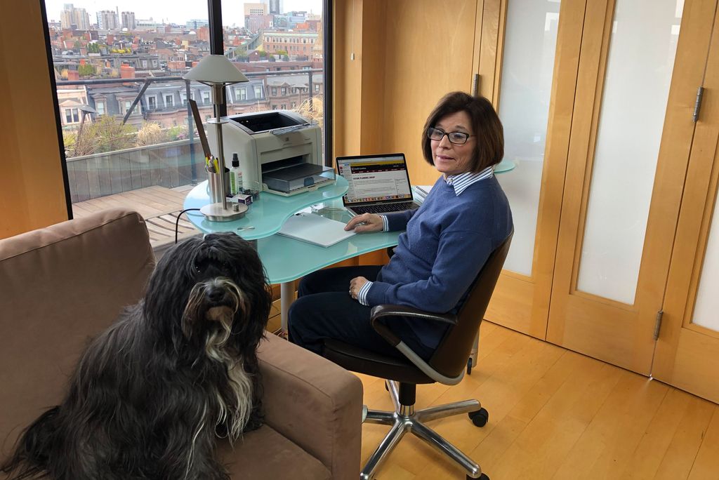 A photo of Gloria Waters at home with her dog