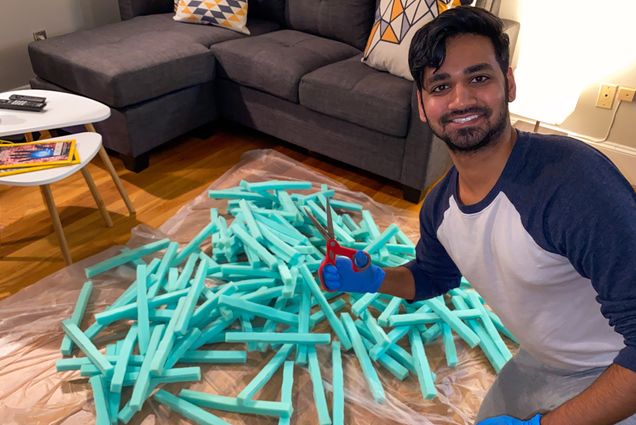 A photo of Ravi Patel (MED’23) assembling face shields for healthcare workers from materials collected by Boston Healthcare for the Homeless