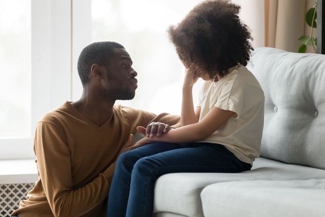 A photo of a father consoling an upset child