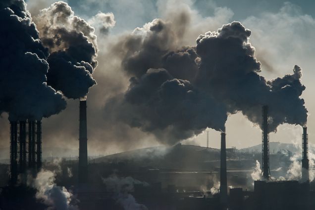 A photo of smokestacks spouting smoke