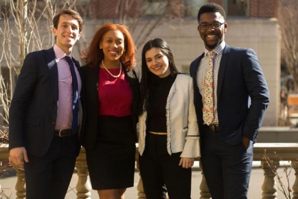 Photo of students in OneBU slate posing with formal attire; the slate includes: President: Oliver Pour (COM’20) Executive VP: David Joseph (CAS’20) VP Finance: Megan De Armas (Questrom’20) VP Internal Affairs: Nyah Jordan (COM’20).