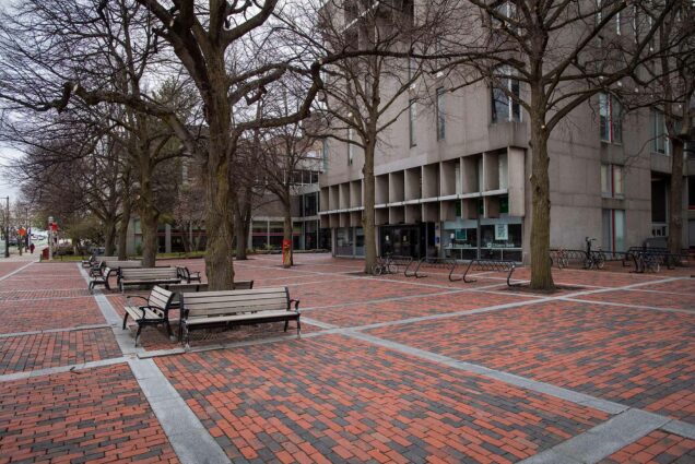 Shot of GSI Plaza in March 2020 on a rainy overcast day. Benches and bare trees are seen.