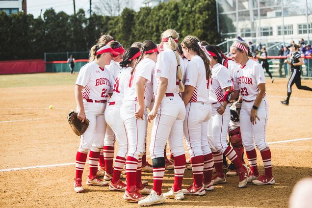 Photo of the BU softball team in a huddle. The team didn’t get to play a single game at home, or even in New England, before the 2020 season was cut short by the coronavirus pandemic.