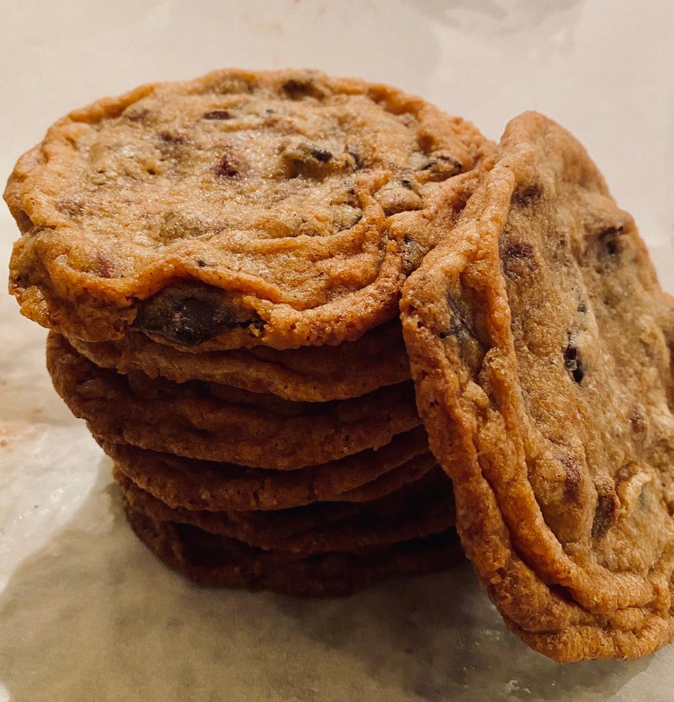 Image of a stack of New York Times' recipe for giant crinkled chocolate chip cookies on a piece of wax paper.