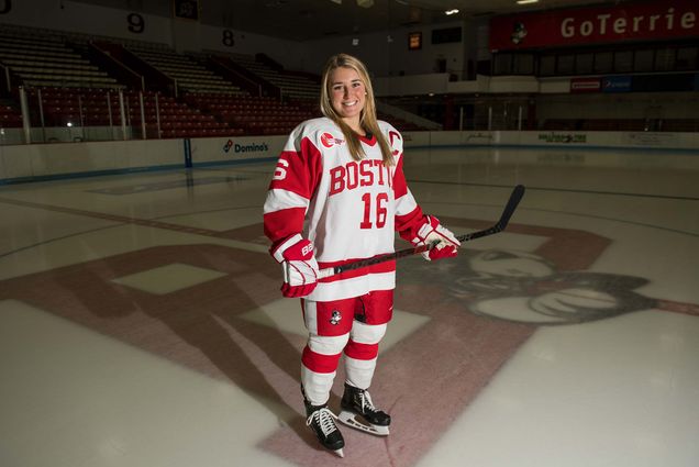 Portrait of Sammy Davis, BU women's ice hockey co-captain and no. 1 overall pick in the 2020 NWHL draft, on the ice at Walter Brown Arena at Boston University