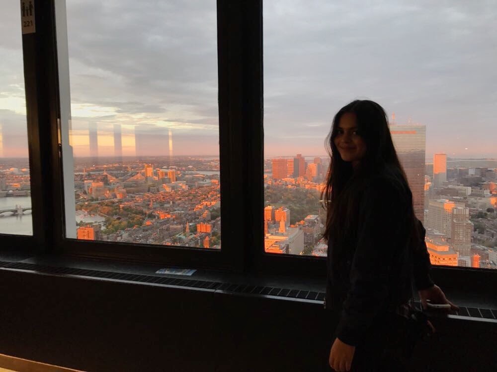 Portrait of Marina Ramirez Lopez (CGS’18, CAS’20) in front of a pink skyline at sunset.