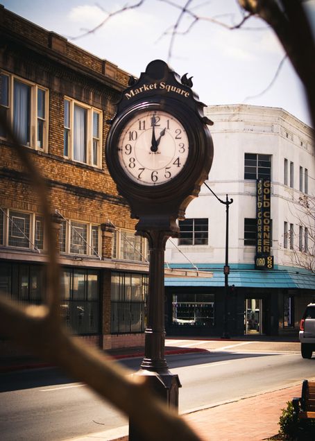 A photo of a clock with the words "Market Square" above it