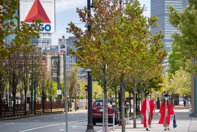 Joe Besser (QST’20) and Michelle Goltsman (COM’20) take a walk down a street near campus on May 16, 2020. The Citgo sign is seen on the left in distance, as well as the green line tracks.