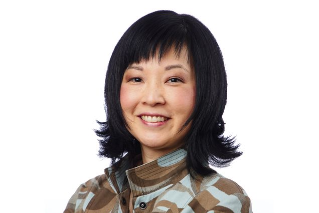 Portrait of Metcalf Award winner Courtney Goto, a School of Theology associate professor of religious education, teaches theology students about racism, culture, and religious faith, on a white background. She wears a blue and brown patterned jacket. Photo by Dave Green