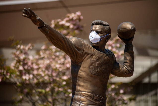 The Harry Agganis statue outside Agganis Arena at Boston University wearing a medical facemask.