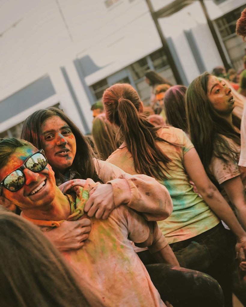 Photo of Divya Advani (CGS’18, COM’20) with colors all over her clothes.