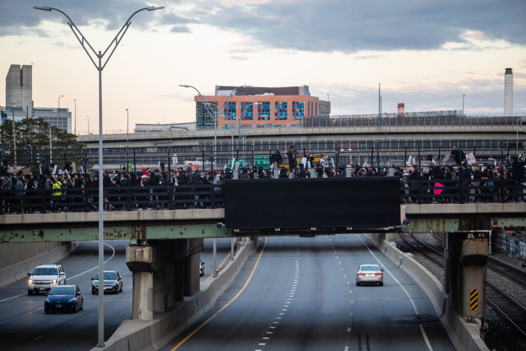 Protestors march over the Mass Pike in Boston