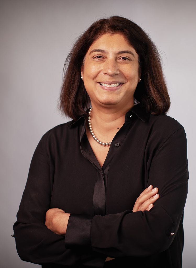 Portrait of Reshma Kewalramani (CAS’98, MED’98) in a black shirt with her arms crossed. Photo courtesy of Vertex Pharmaceuticals