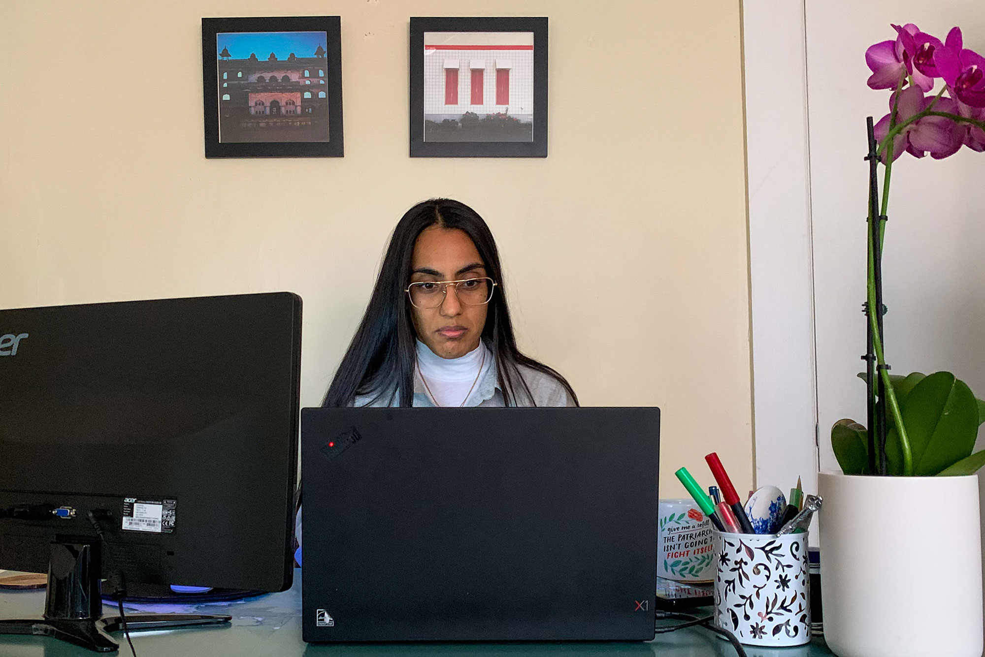 Photo of Pawandeep Kaur sitting at a desk with a computer as she works. Kaur is in SPH’s Doctor of Public Health program, and is juggling her volunteer responsibilities with her coursework and her full-time job as a clinical trial director at SPH.