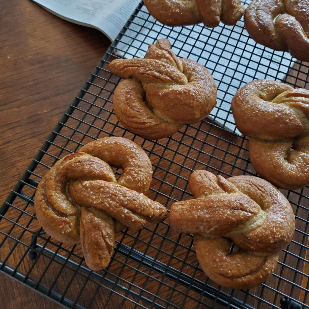 Image of homemade rye pretzels on a cooling rack. 