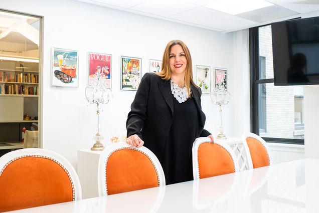 A portrait photo of Marlo Fogelman standing in a conference room