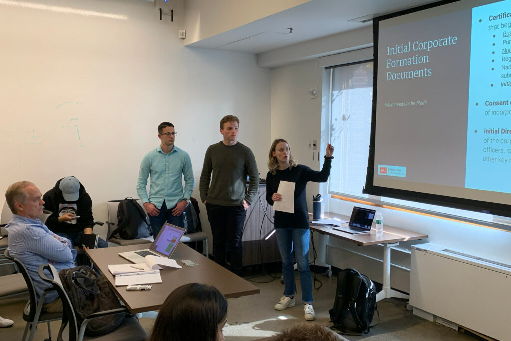 Startup Law Clinic members (from left) Harry Brown (LAW’20), James Christopher (LAW’20), and Tyler Isaman (LAW’20), as Isaman outlines to an audience of MIT students what it takes to form a corporation.