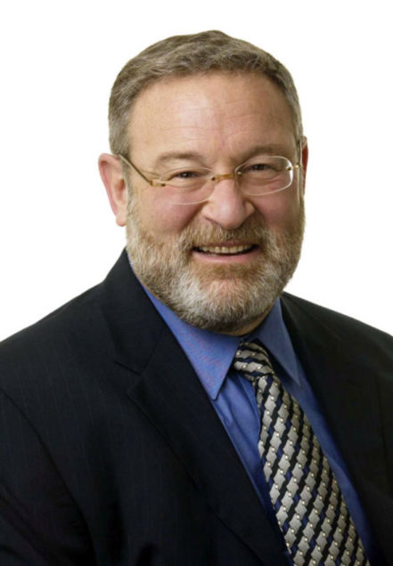 Headshot of Zvi Bodie, Questrom School of Business professor emeritus, wearing a suit and tie on a white background.