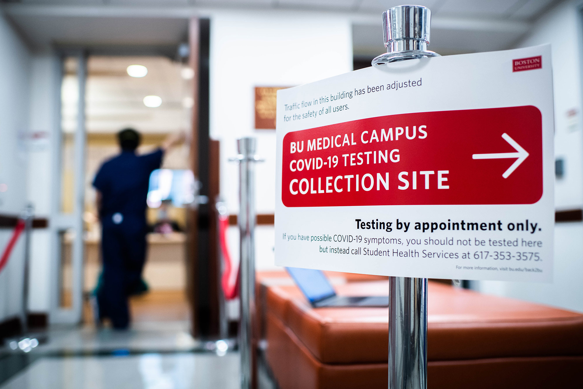 Sign at the the Covid-19 testing collection site on the BU Medical Campus on July 27, 2020. Sign reads “BU Medical Campus COVID-19 Testing Collection Site” in a red box with an arrow pointing to the right. Bolded text below reads “Testing by appointment only.”