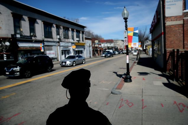 A Boston Police officer in silhouette on the street