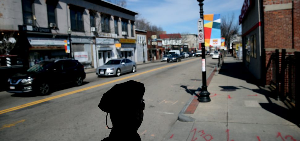 A Boston Police officer in silhouette on the street