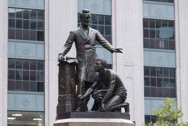 The Emancipation Group statue in Boston's Park Square. The statue shows Abraham Lincoln towering over a crouched and half-naked formerly enslaved man, Archer Alexander.