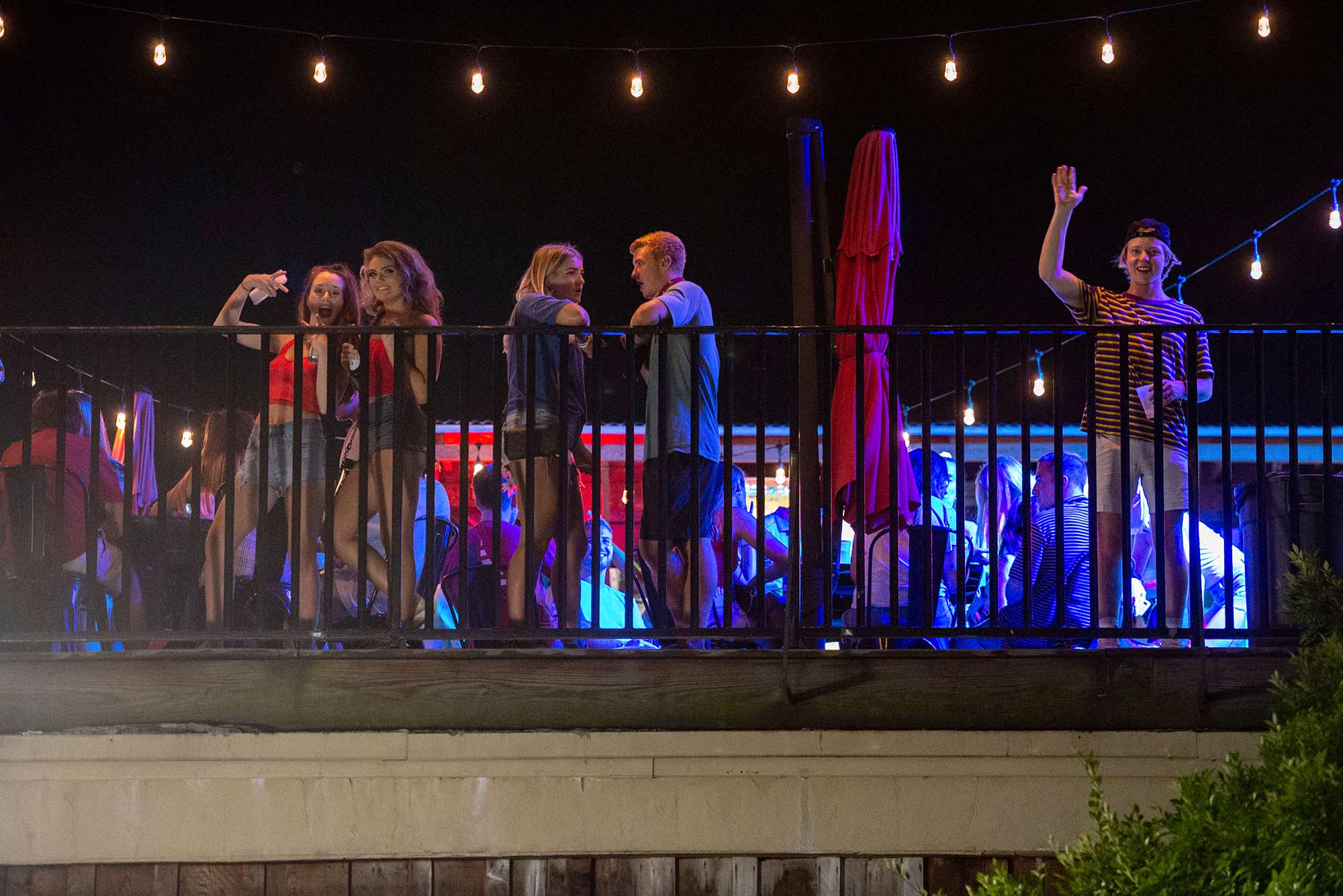 Patrons without facemasks on the rooftop bar at The Bear Trap on The Strip, Tuscaloosa, Alabama