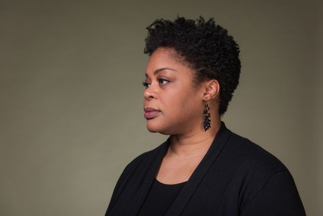 Portrait of Crystal Williams, a College of Arts & Sciences professor of English, who leads BU efforts on diversity and inclusion who has been recently promoted to Vice President and Associate Provost of Community and Inclusion. In the portrait, Williams wears a black blouse and earrings, and looks off into the distance on a dark green backdrop.